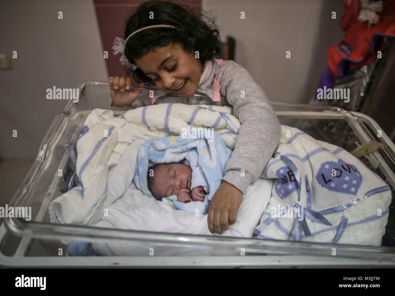Gaza. 11th Feb, 2018. A Palestinian newborn baby is seen inside a hospital in Gaza City, on Feb. 11, 2018. The test-tube baby, named Mujahid, has been born with the smuggled sperm of his father who has been sentenced for seven years in Israeli jail. Many Palestinian women with husbands serving long terms in Israeli jails have resorted to sneaking sperm out and getting pregnant. Credit: Wissam Nassar/Xinhua/Alamy Live News Stock Photo