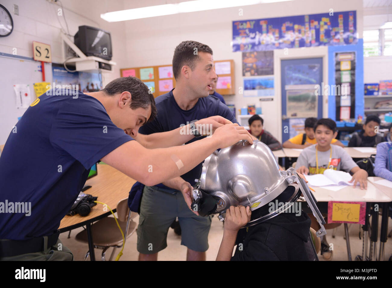 Divers from the U.S. Coast Guard Regional Dive Locker Pacific allows students to try on gear at