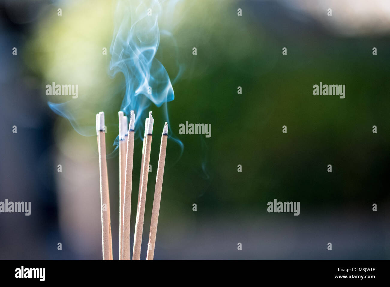 burning Embossed sticks and smoke from incense burning and smoke Stock