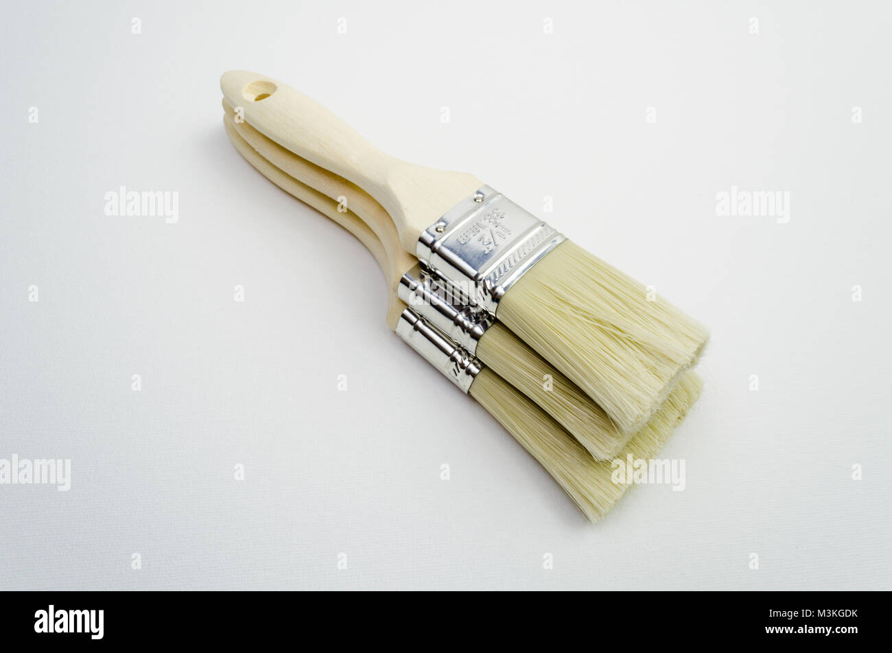 A Studio Photograph of Three Wooden Handled Paintbrushes Stock Photo