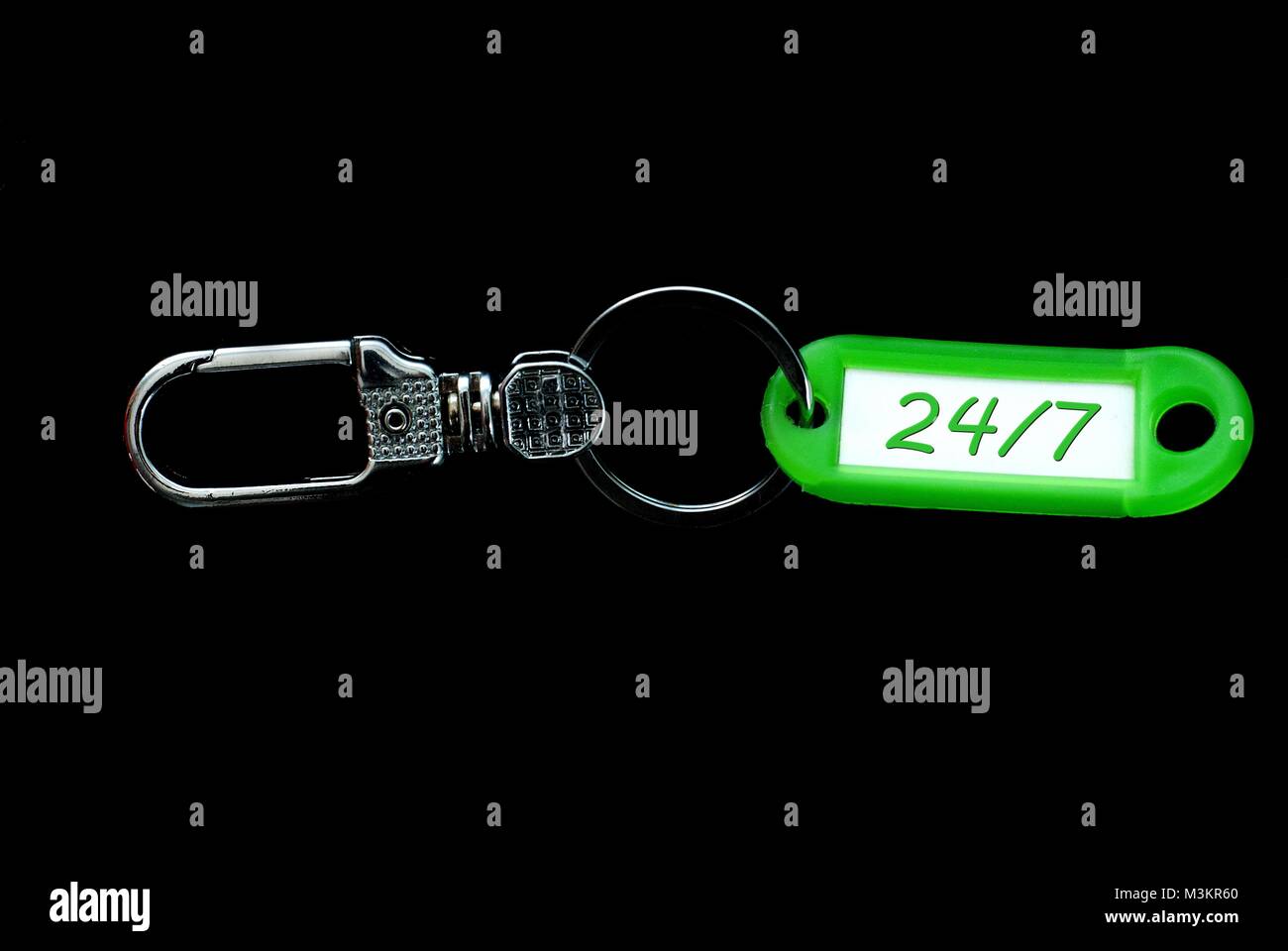 Key holder green label holder with numbers 24 and 7 Stock Photo