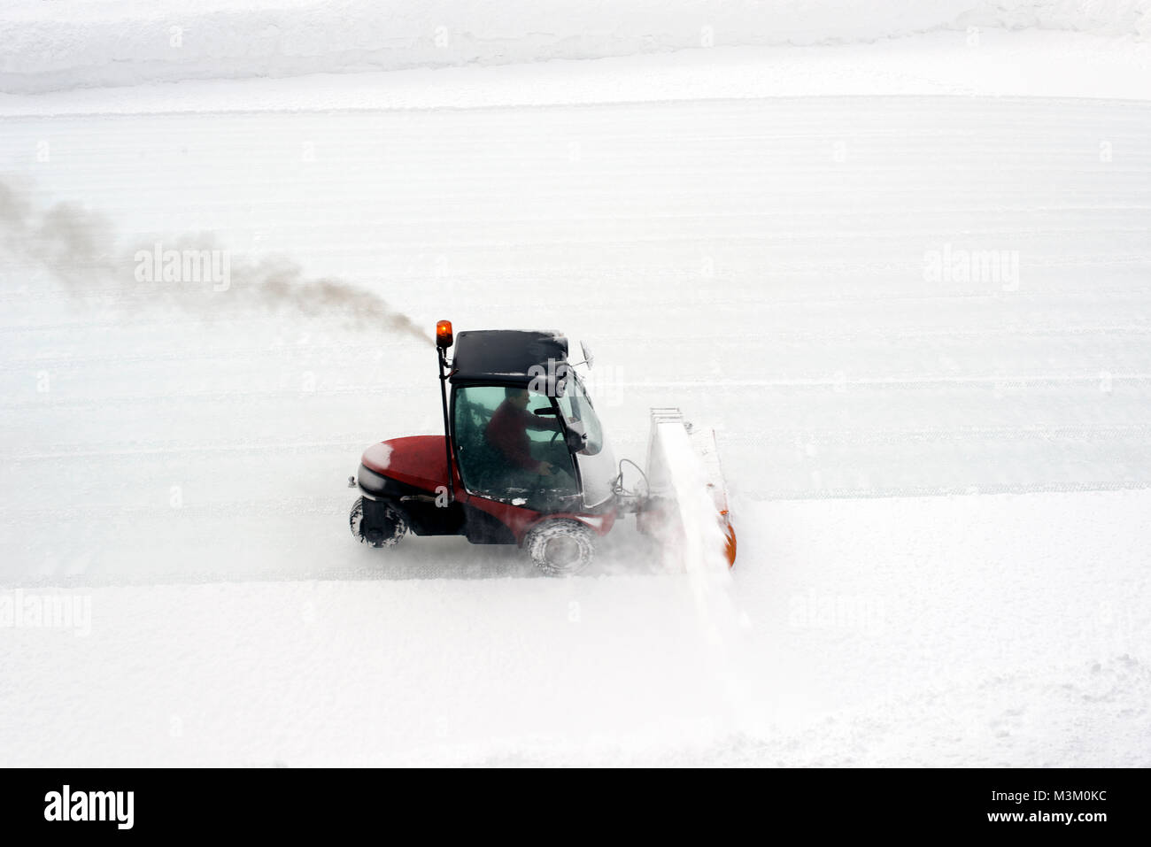 An ice skating piste and ice skating machine cleaning the snow in the