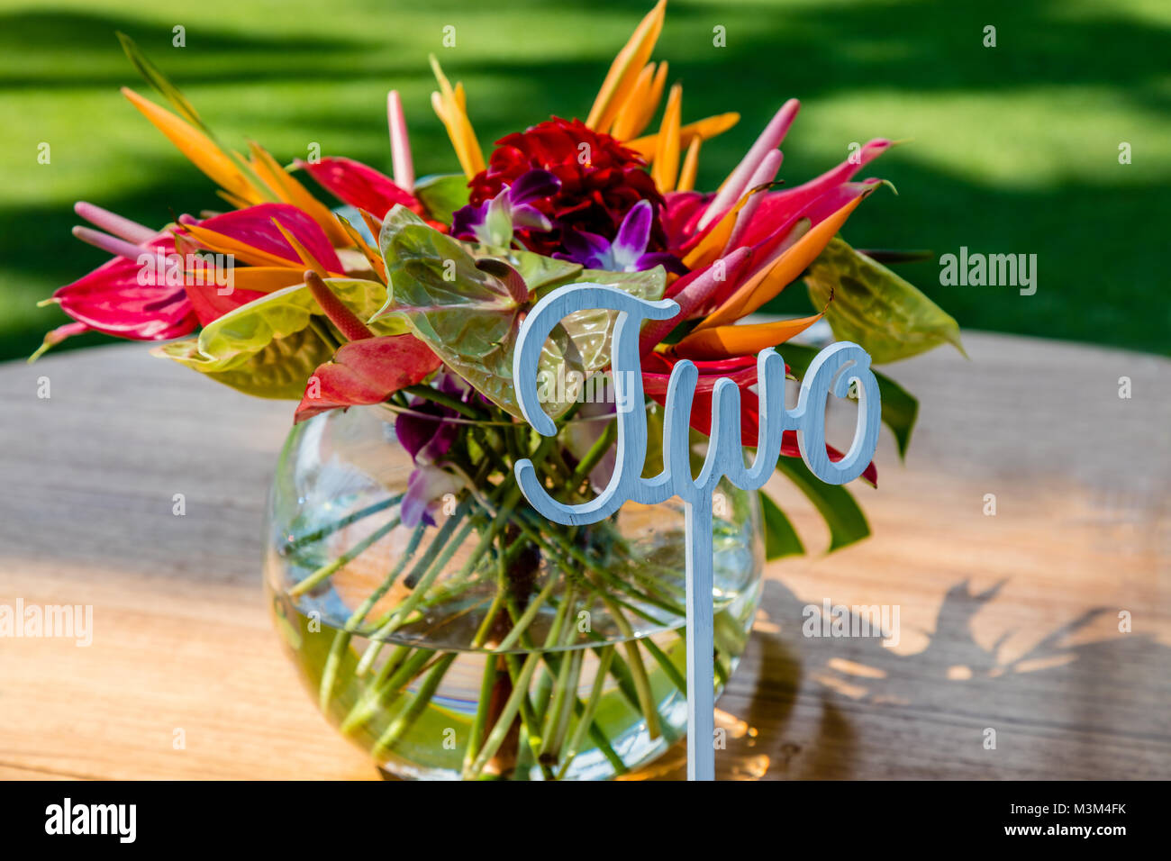 Wedding Setup Table Number Two And A Bouquet Of Tropical Flowers Stock Photo Alamy