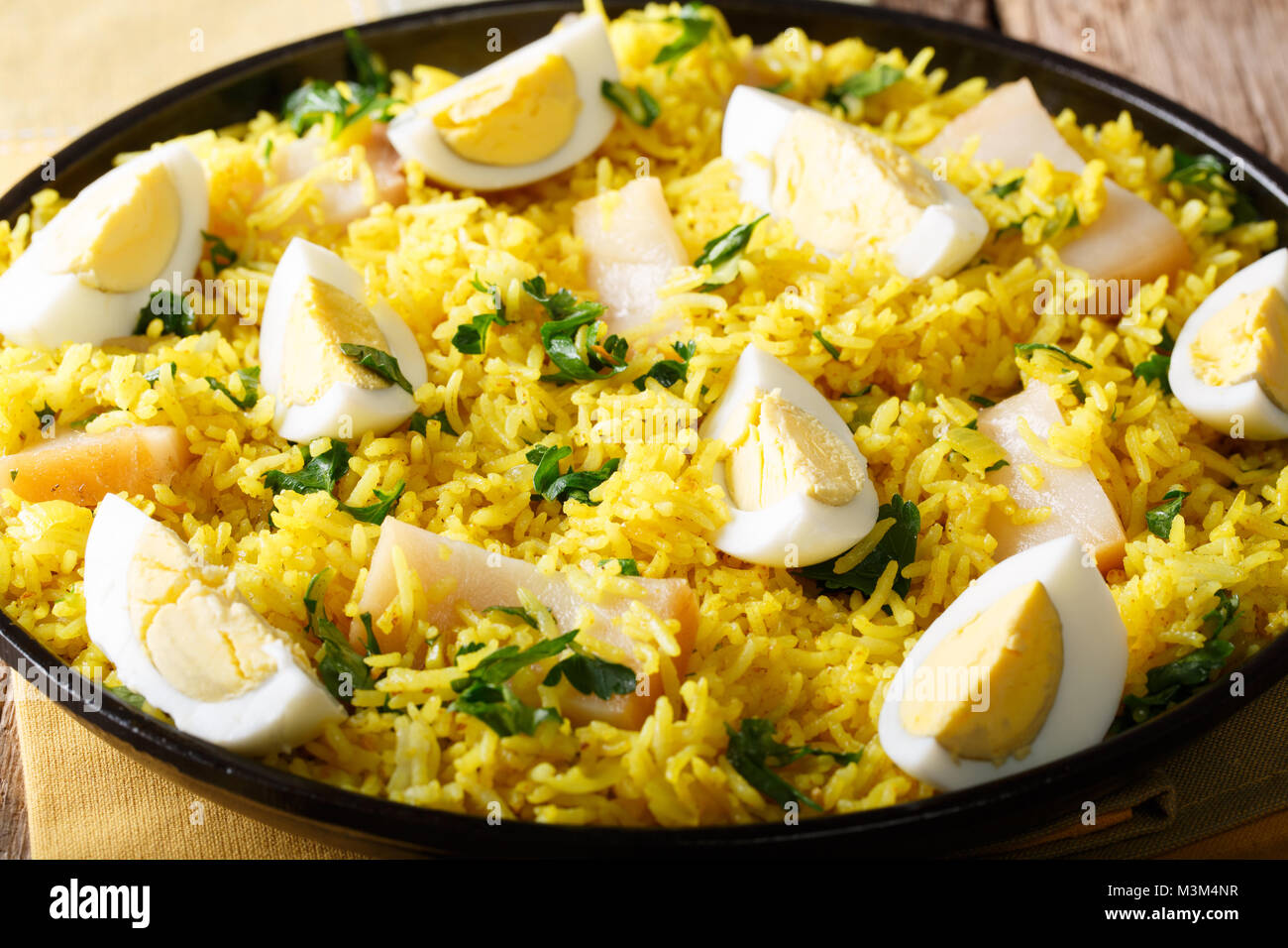 Kedgeree with smoked fish, eggs and spices closeup on a plate. horizontal Stock Photo Alamy