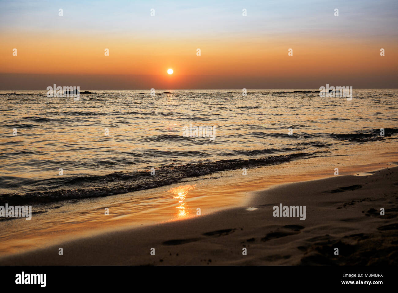 Scenic view of a summer sunset on the Ionian sea near Gallipoli, a town in the Apulian region (Italy). Landscape format. Stock Photo