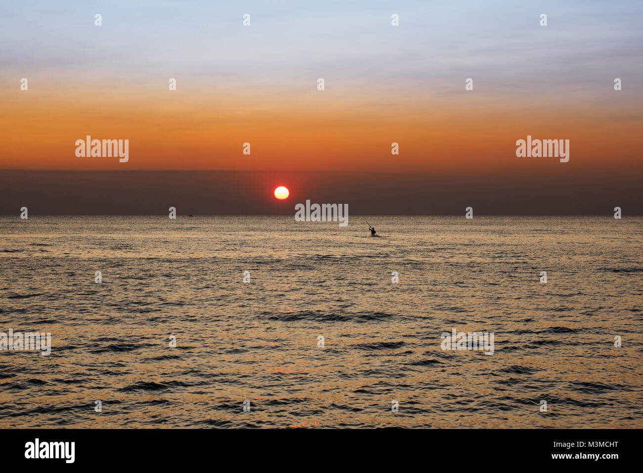 Scenic view of a summer sunset on the Ionian sea near Gallipoli, a town in the Apulian region (Italy). Landscape format. Stock Photo