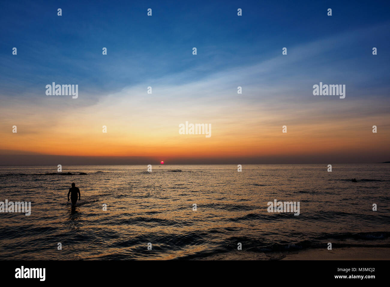 Scenic view of a summer sunset on the Ionian sea near Gallipoli, a town in the Apulian region (Italy). Landscape format. Stock Photo