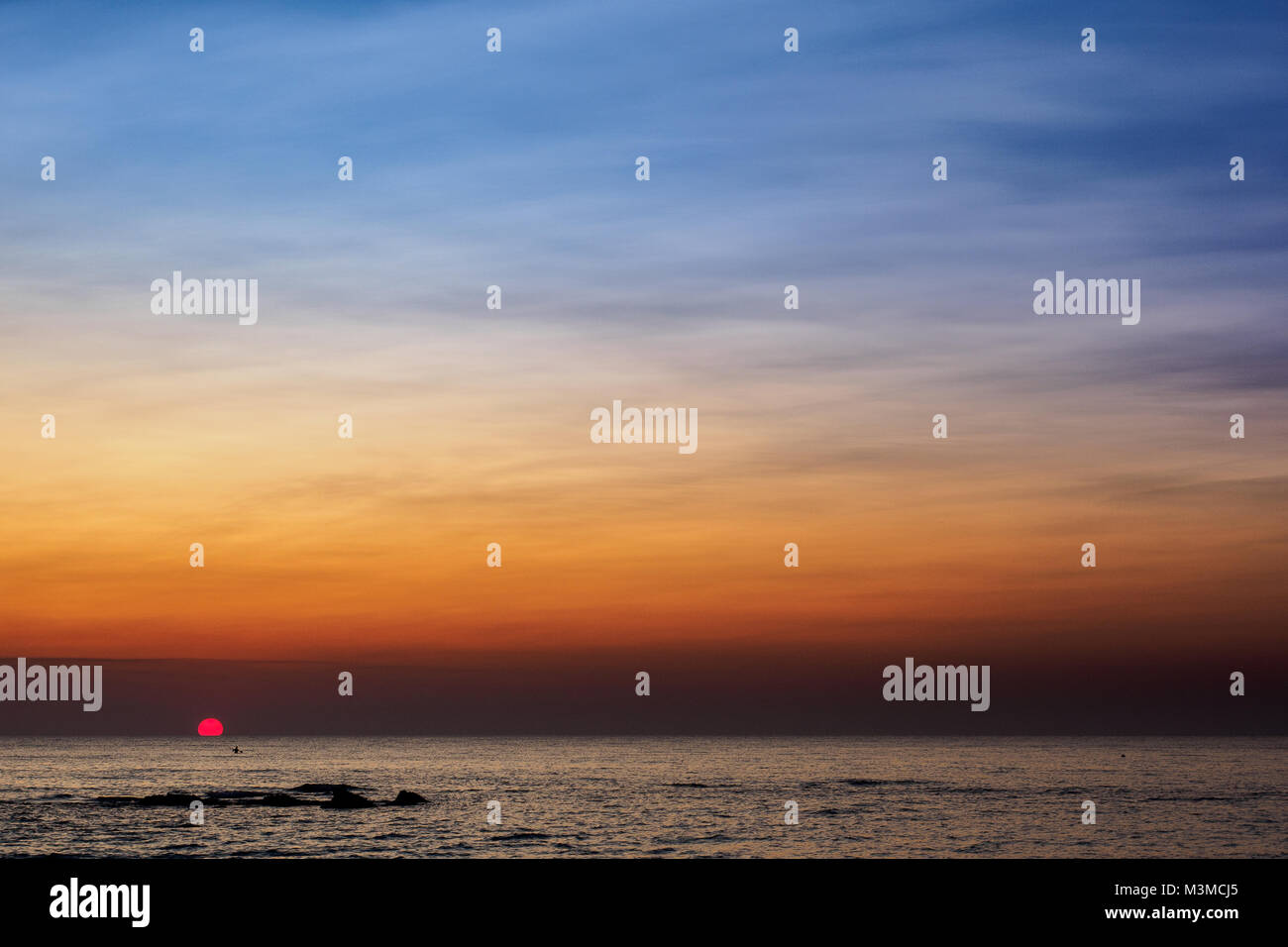 Scenic view of a summer sunset on the Ionian sea near Gallipoli, a town in the Apulian region (Italy). Landscape format. Stock Photo