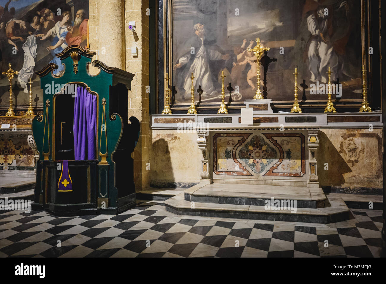 Gallipoli (Italy), August 2017. View of a lateral nave altar with a confession booth in the Sant'Agata Cathedral in the town centre of Gallipoli. Stock Photo