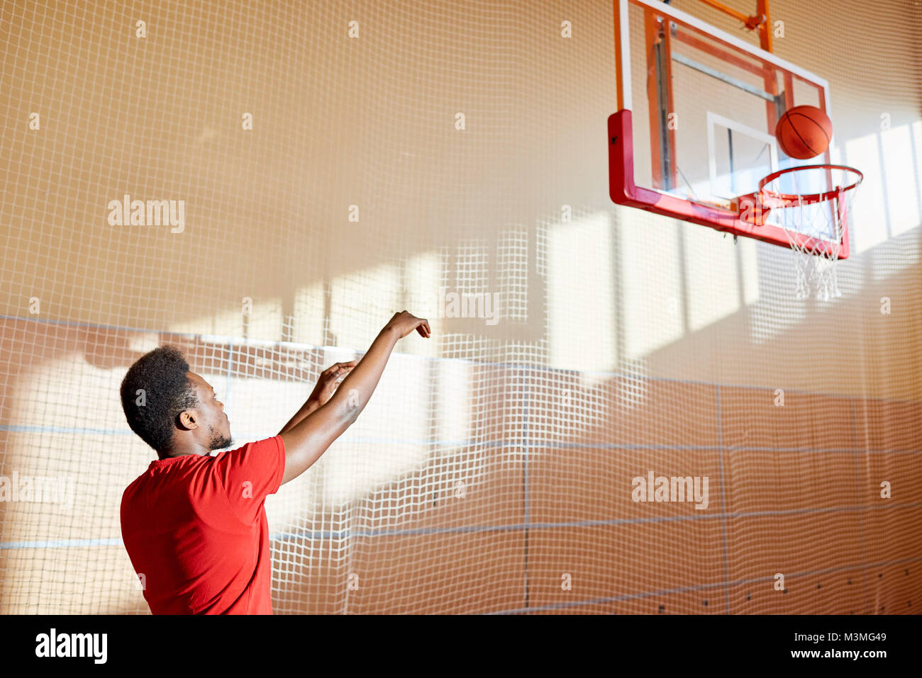 Skilled young basketball player training on court Stock Photo