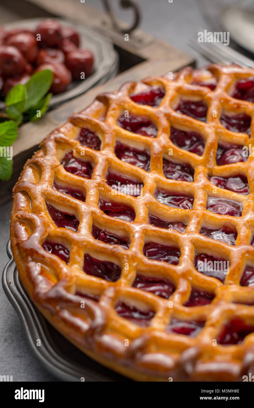 Homemade open sour cherry pie, delicious sweet dessert served on gray ...