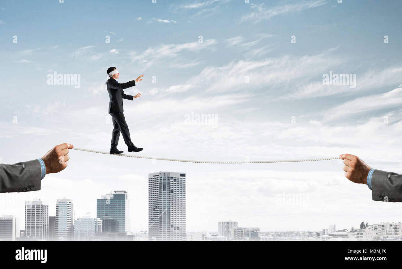 Business concept of risk support and assistance with man balancing on ...