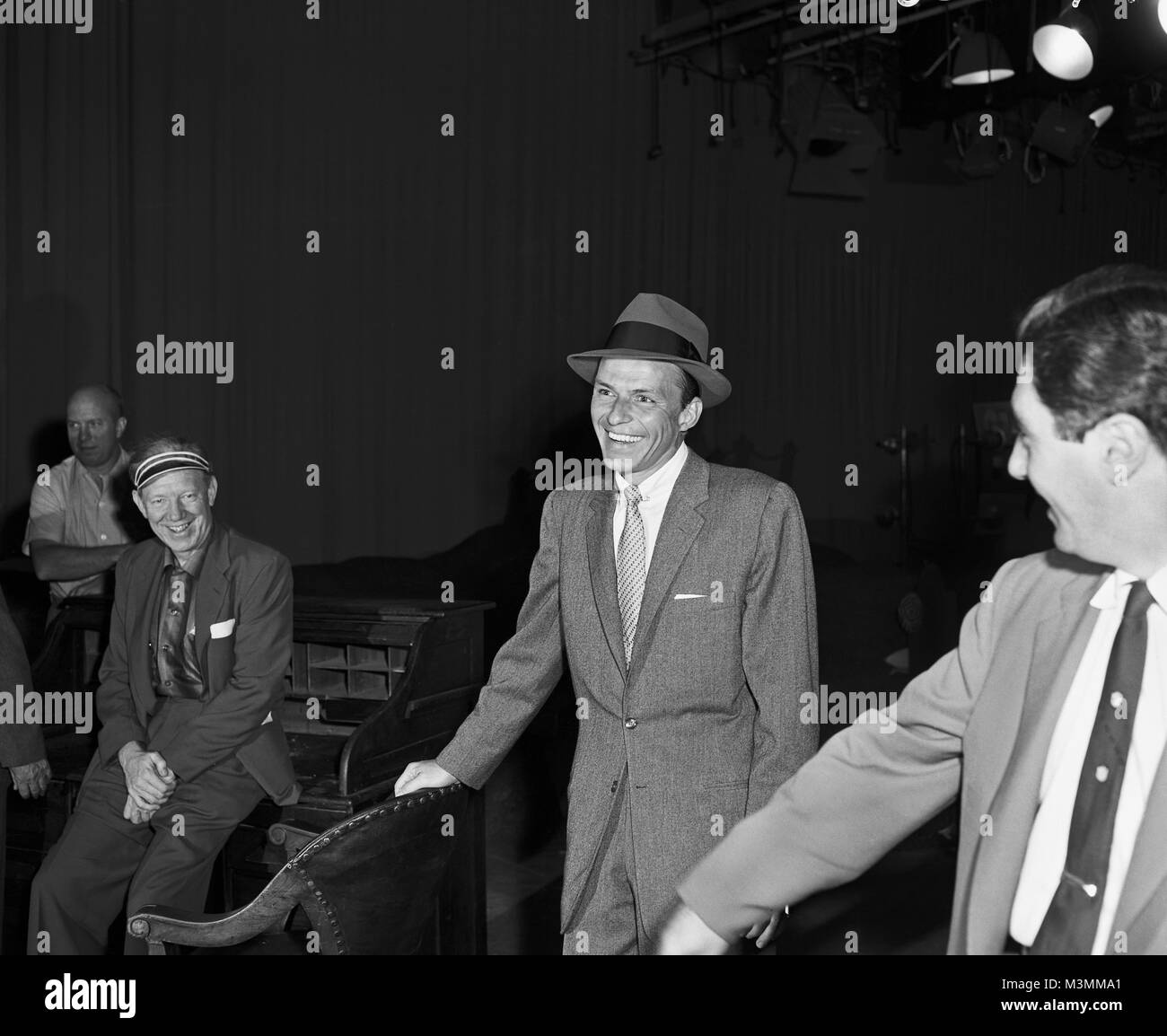 Frank Sinatra on the set of “Our Town”, 1955. Sinatra played the Stage Manager in this musical adaption of the Thornton Wilder play.  In this production, he introduced his well-known signature song, Love and Marriage. Original camera negative. Stock Photo