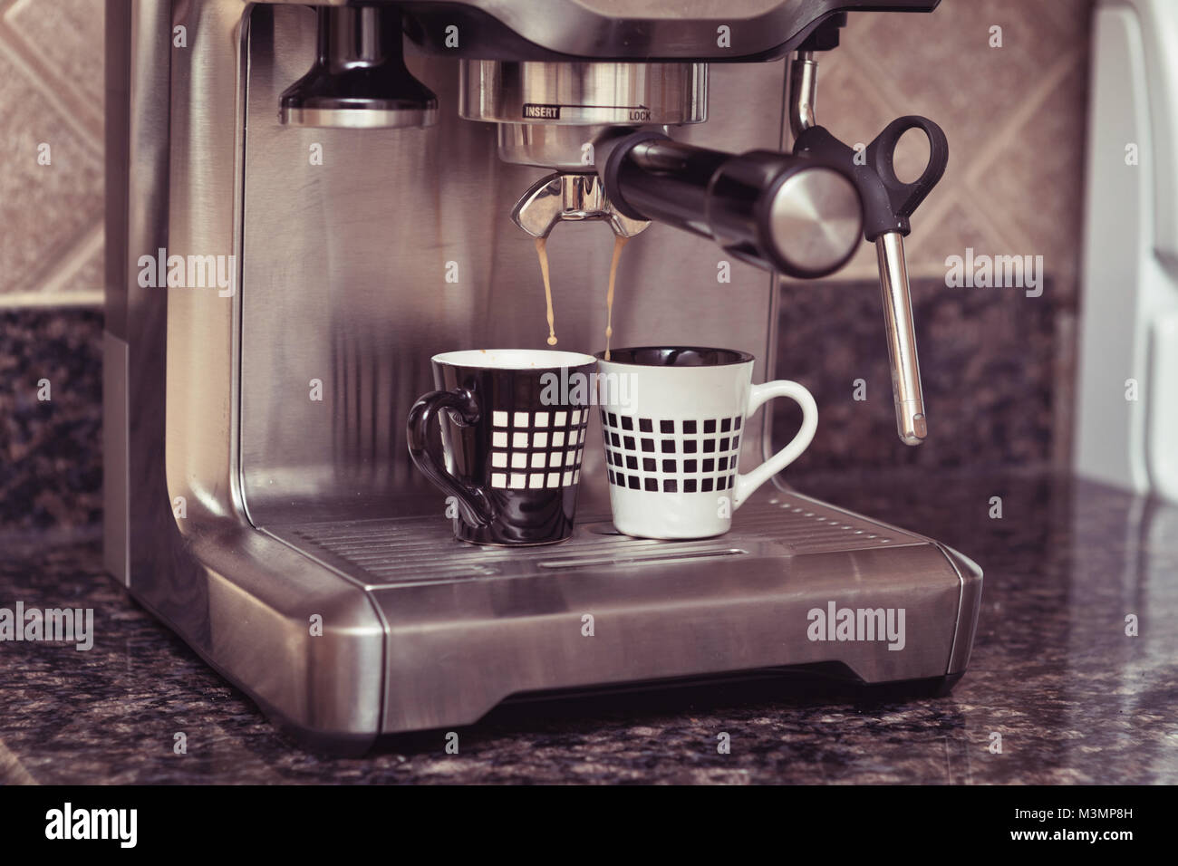 https://c8.alamy.com/comp/M3MP8H/home-espresso-machine-on-kitchen-counter-top-making-two-cups-coffee-M3MP8H.jpg