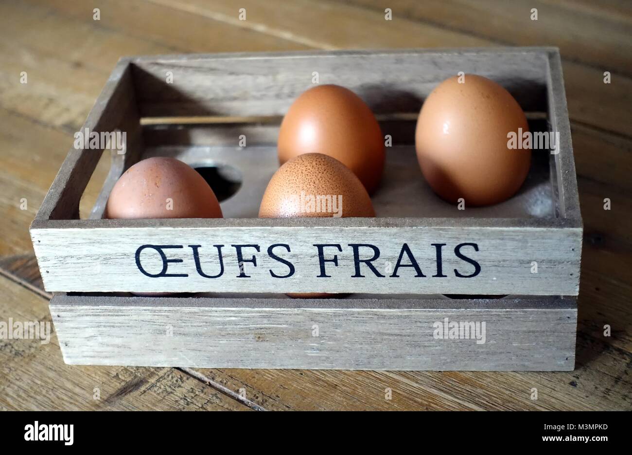 Four Brown Eggs In A Wooden Box With The French Words Oeufs Frais Fresh Eggs On The Sode Stock Photo Alamy