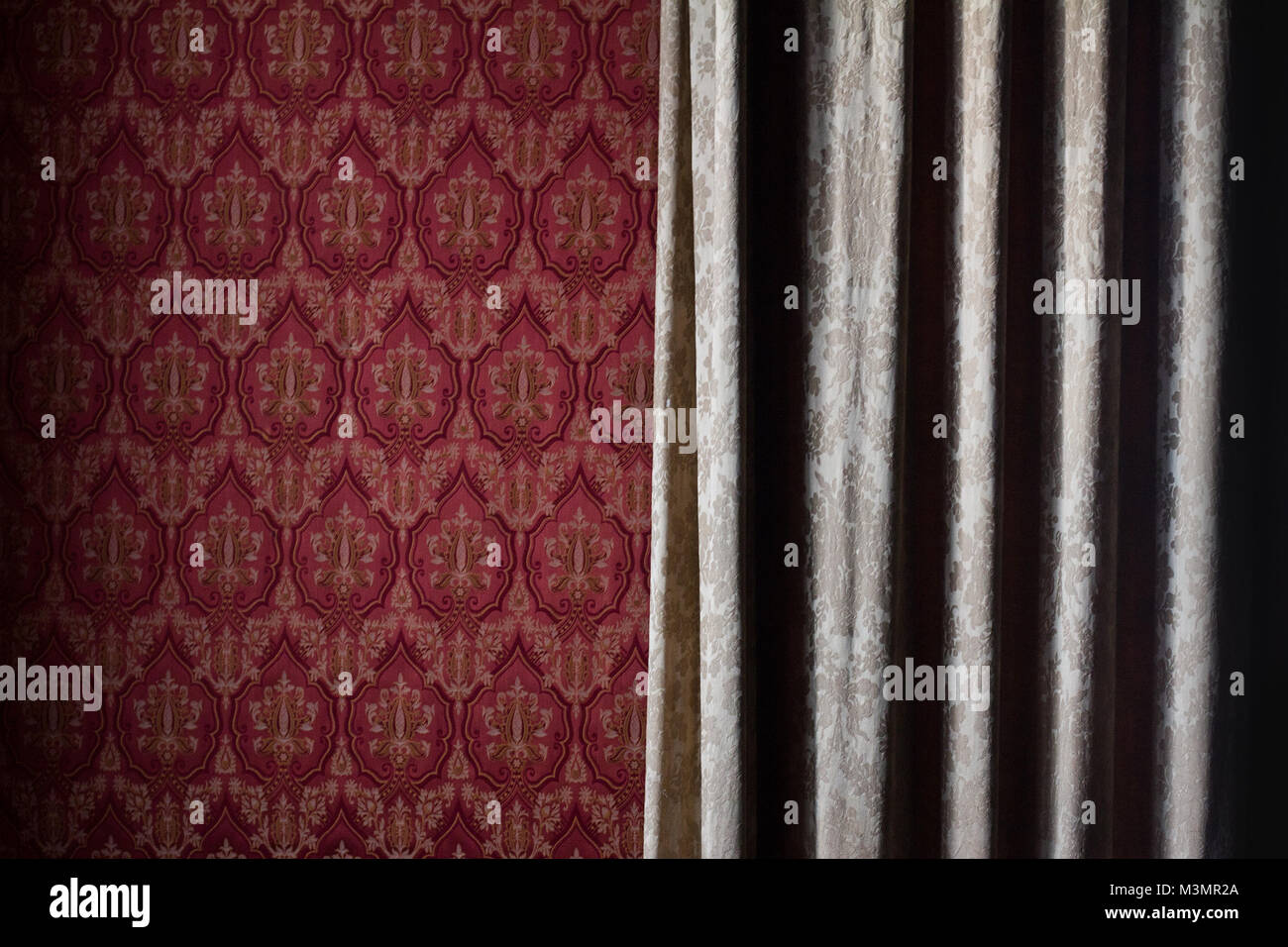 Front View Close Up Detail Of Light Cream Colored Curtain Covering Red Wallpaper Wall With Classic Front View Close Up Detail Of Light Cream Colored Curtain Covering Red Wallpaper Wall With Classic