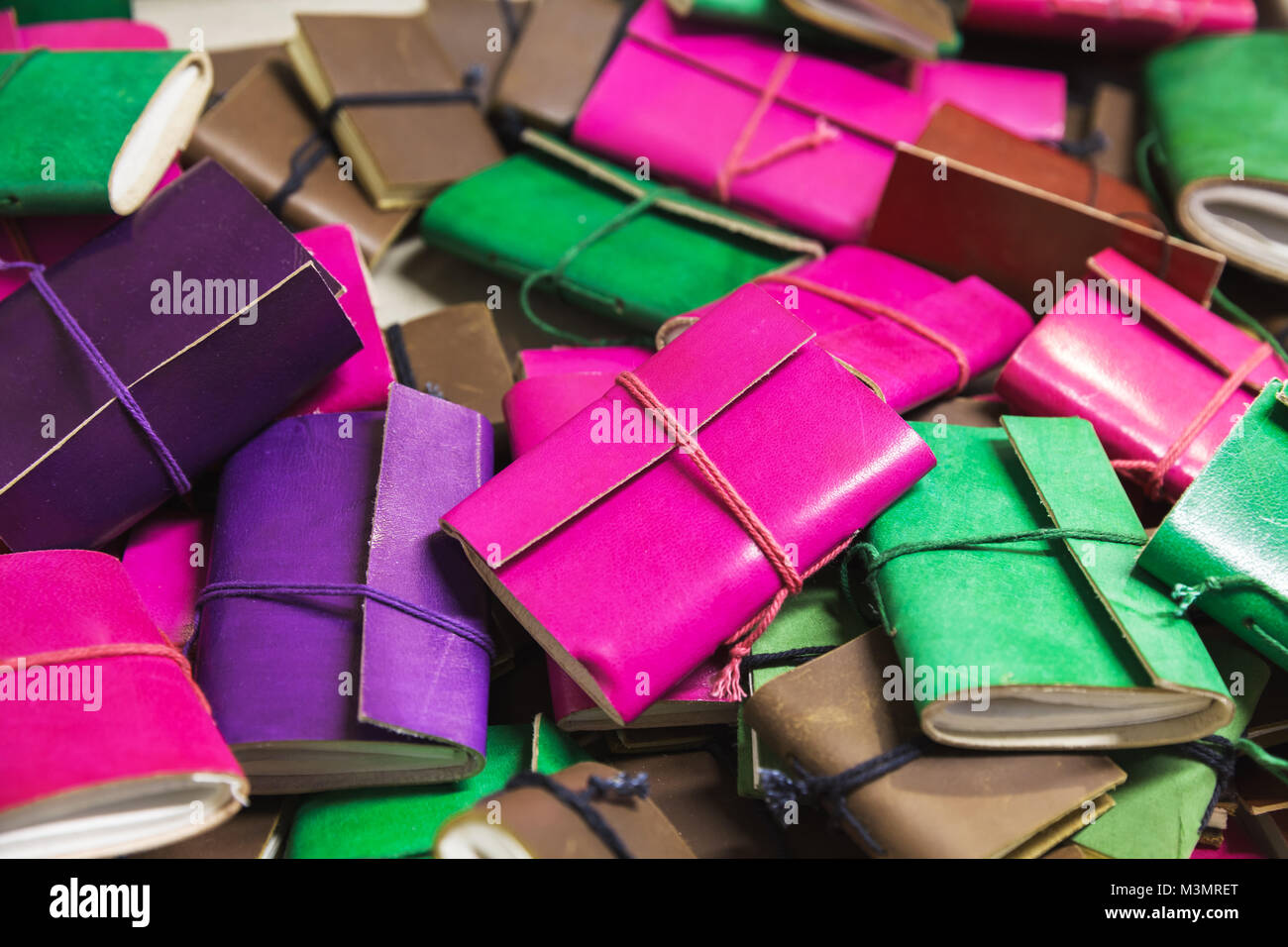 Pile of colorful notepads in leather bindings Stock Photo