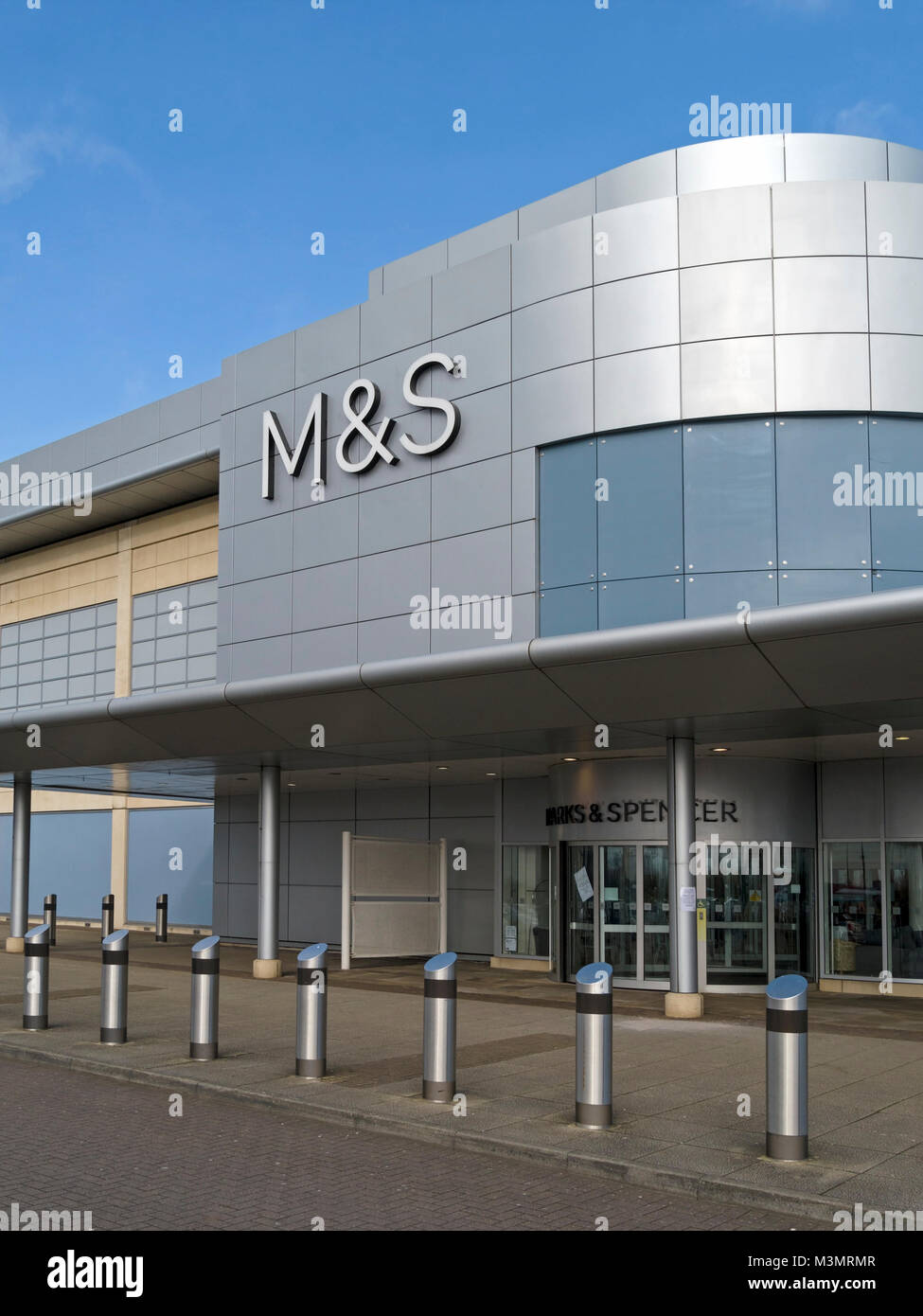 Exterior and entrance of modern Marks and Spencer shop store with M&S logo and blue sky above, The Mall at Cribbs Causeway, Bristol, England, UK Stock Photo
