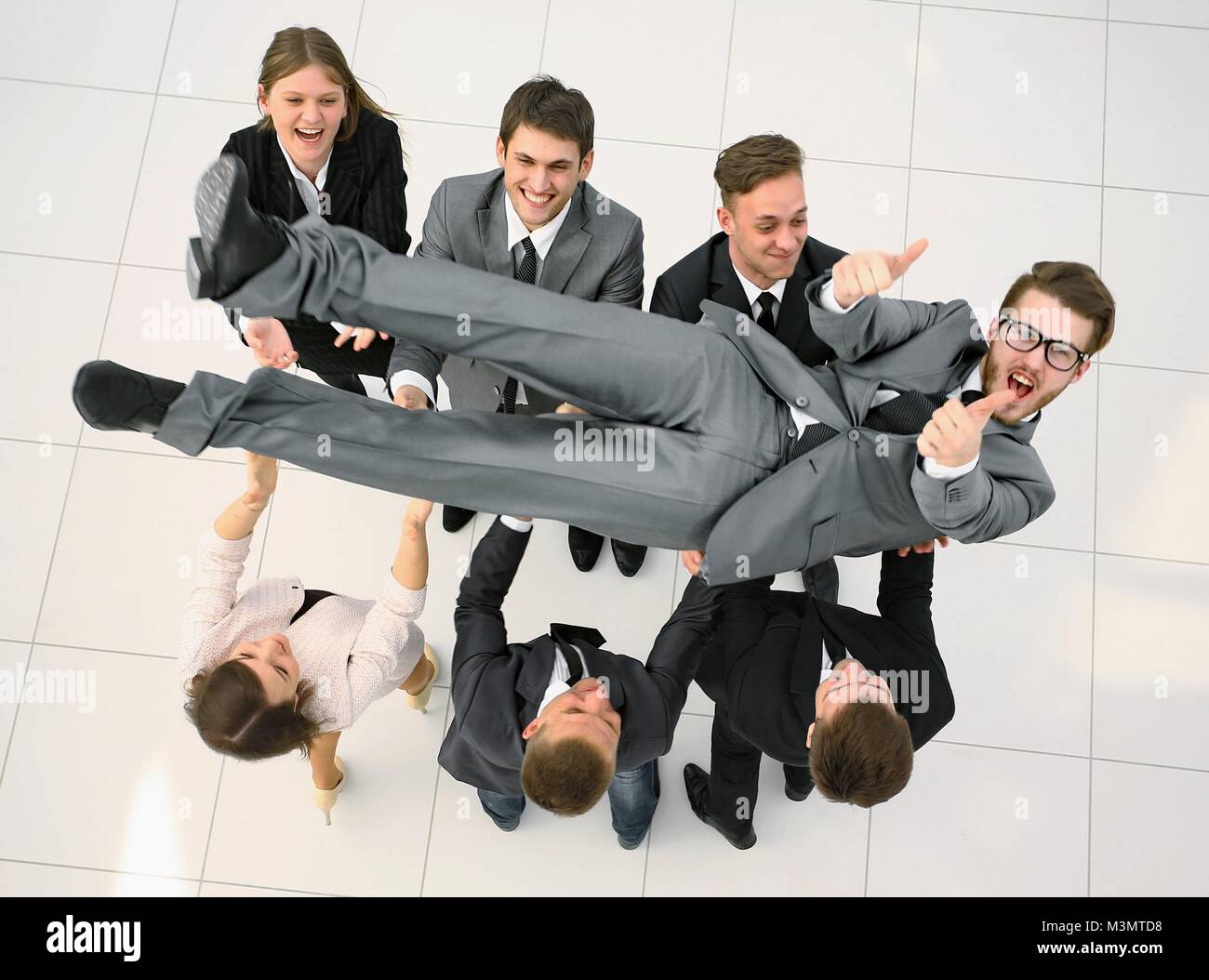 triumphant business team shakes their leader Stock Photo - Alamy