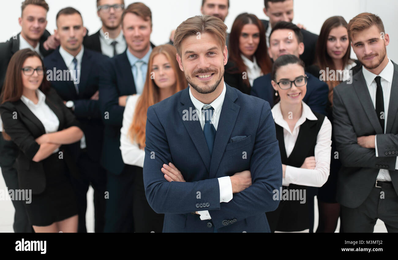 smiling businessman standing on background of her business team Stock ...