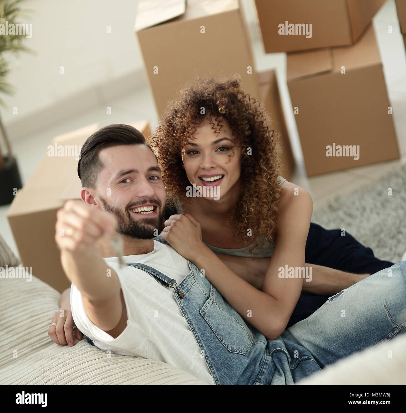 young couple holding the key to a new apartment Stock Photo - Alamy