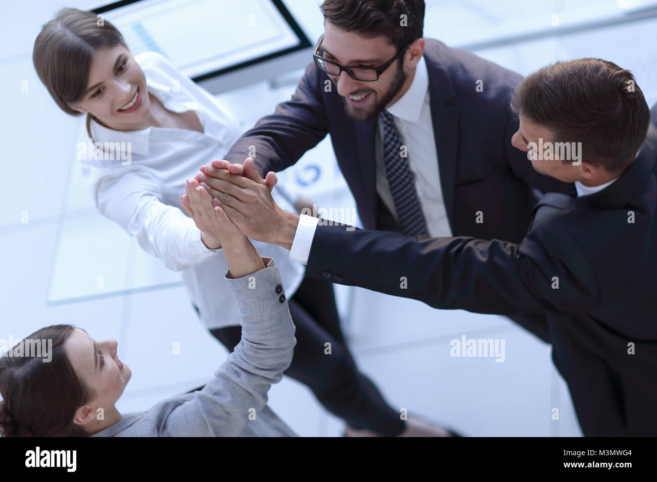 successful business team giving each other a high-five, standing in the ...