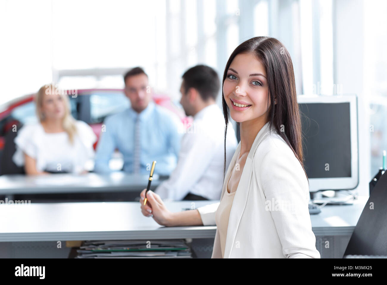portrait of young business woman sitting at the Desk Stock Photo - Alamy