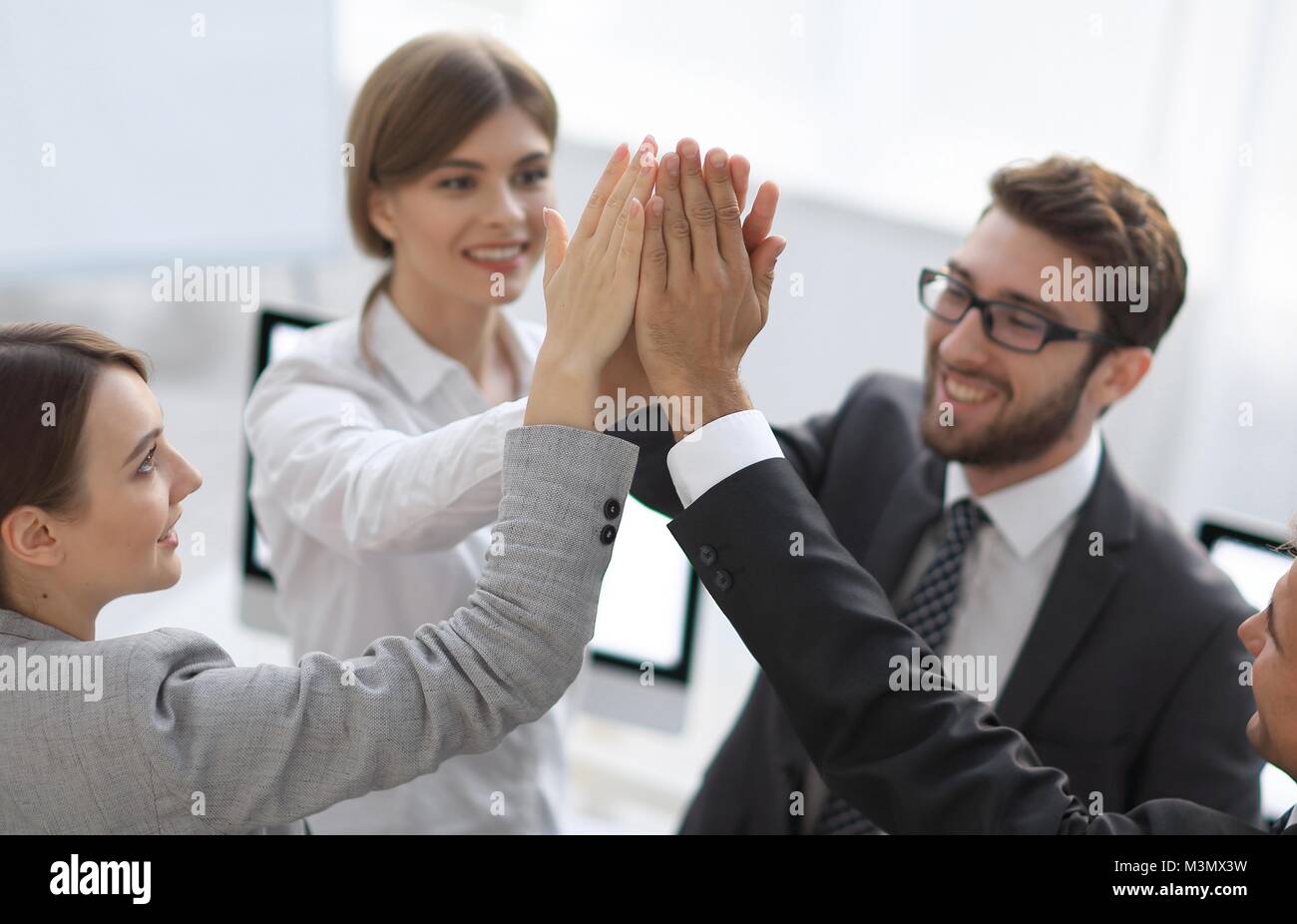 successful business team giving each other a high-five, standing in the ...