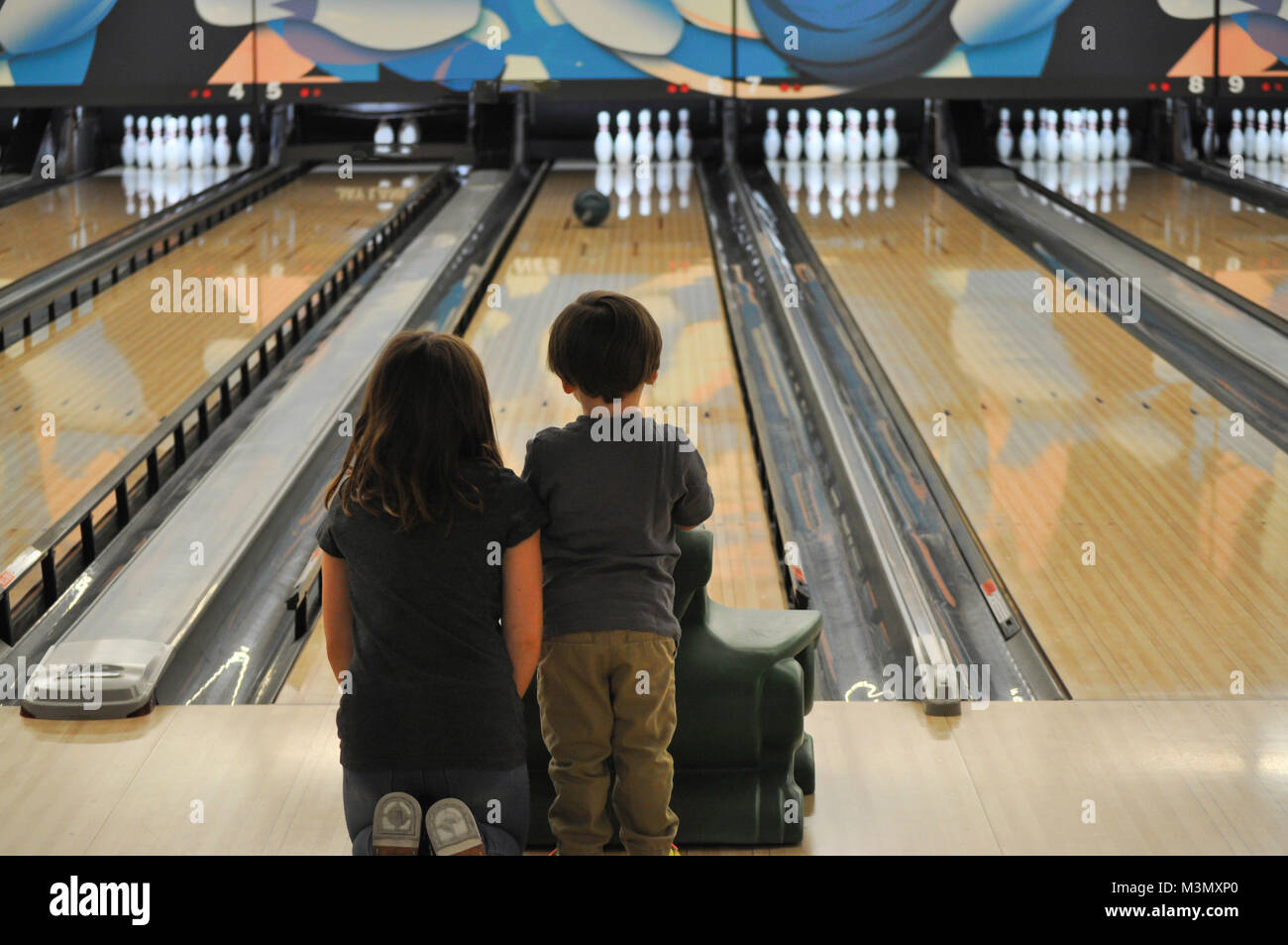 Young Brother and Sister Bowling Stock Photo