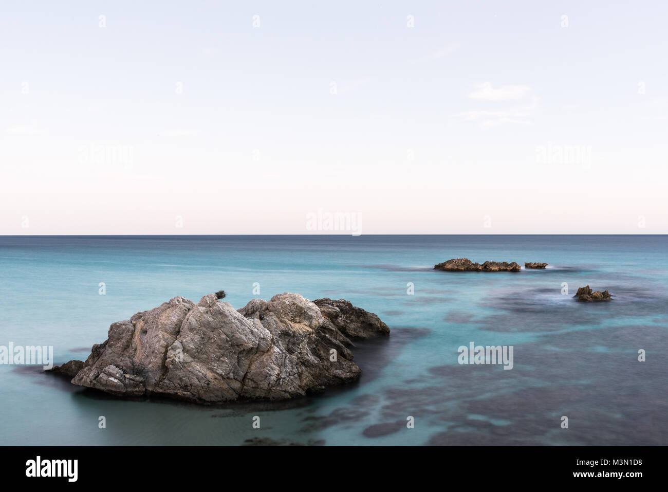 Long exposure photograph of the shore of the coast of Cala Moll in the mediterranean sea of Palma de Mallorca. Stock Photo