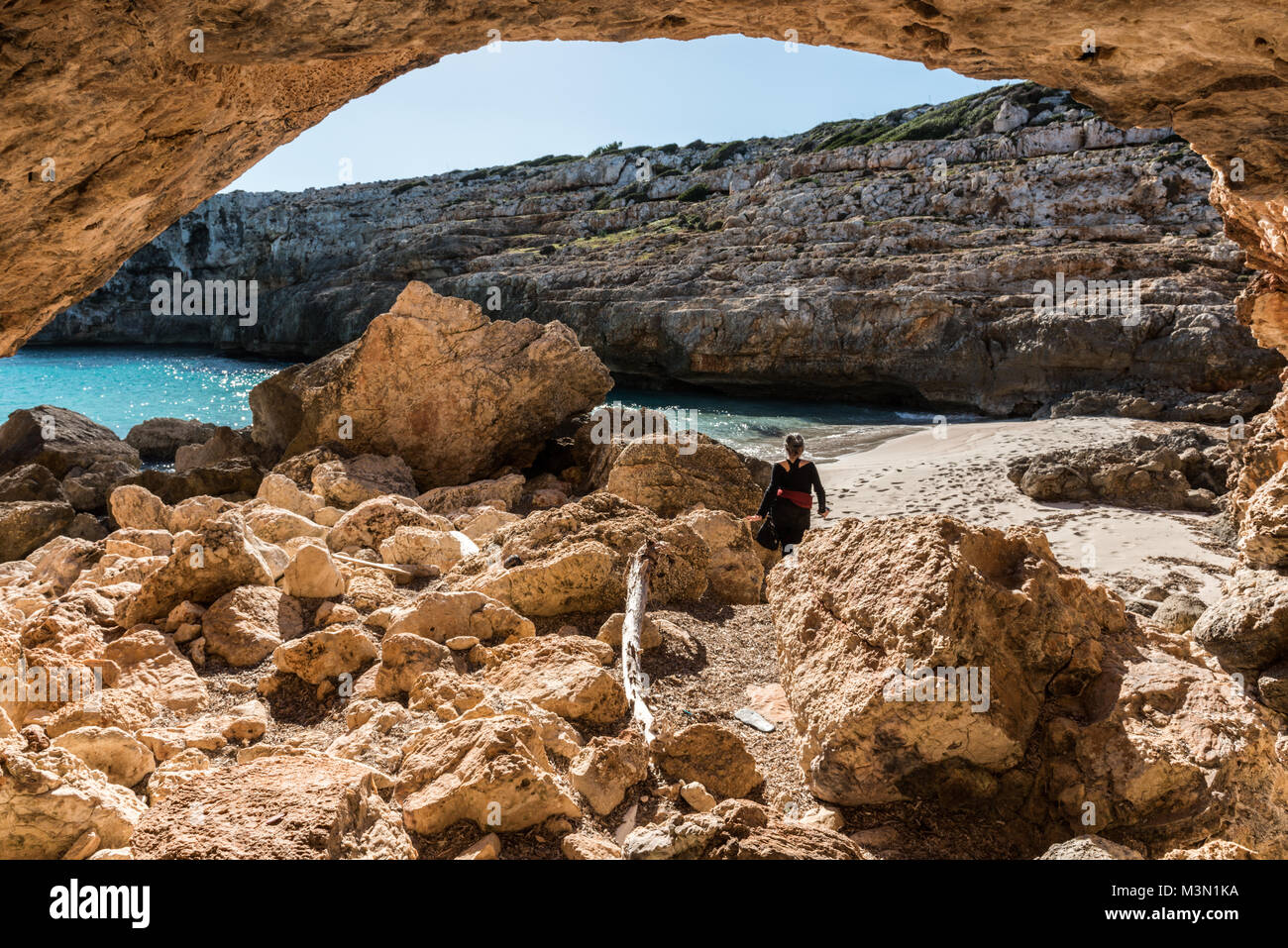 A Young Brunette With Gray Hair Leaves One Of The Caves Of Cala Falco a-young-brunette-with-gray-hair-leaves-one-of-the-caves-of-cala-falco