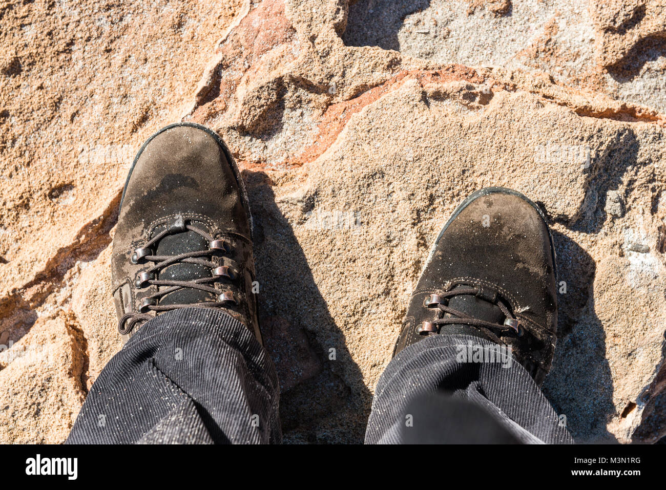 The feet of a man with a wet hiking boots on a rock on a beach in Palma de  Mallorca, Spain Stock Photo - Alamy