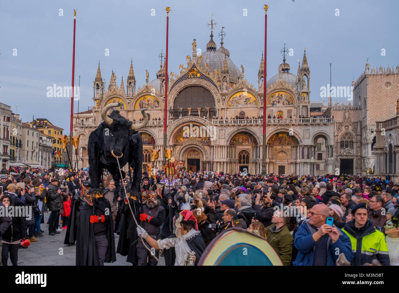 VENICE, ITALY - FEBRUARY 11: People wearing costumes attend the traditional events of Carnival 'Cutting off the Bull's head' and 'Dance of the Masks'  Stock Photo