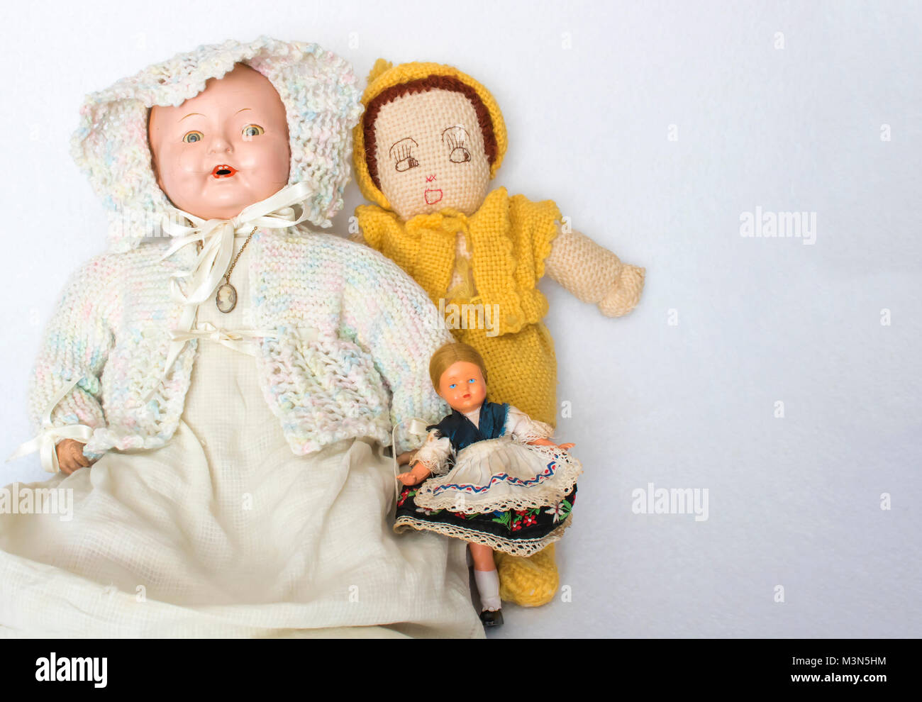 Group of Three Antique Dolls on White Background Stock Photo