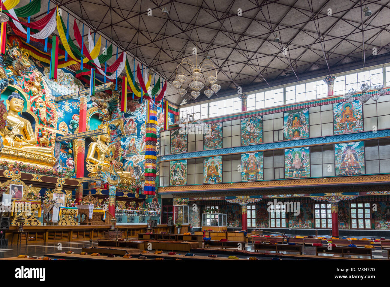 Coorg, India - October 29, 2013: Inside Padmasambhava Vihara of Namdroling Buddhist Monastery. Right side with wall paintings and windows. Buddha and  Stock Photo