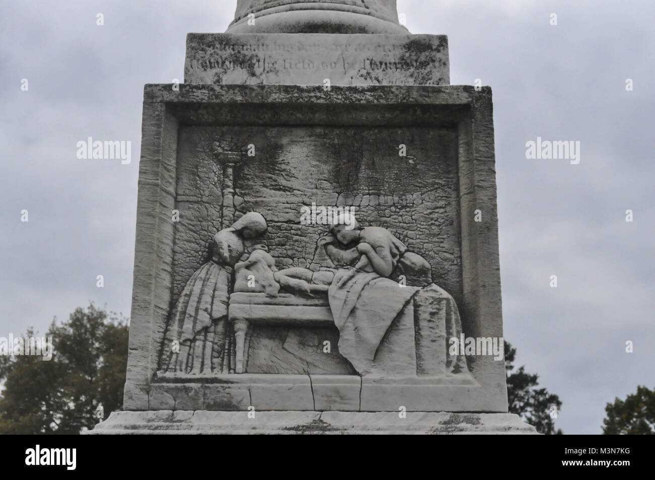 Statue of People Tending to a Loved One on their Deathbed Stock Photo