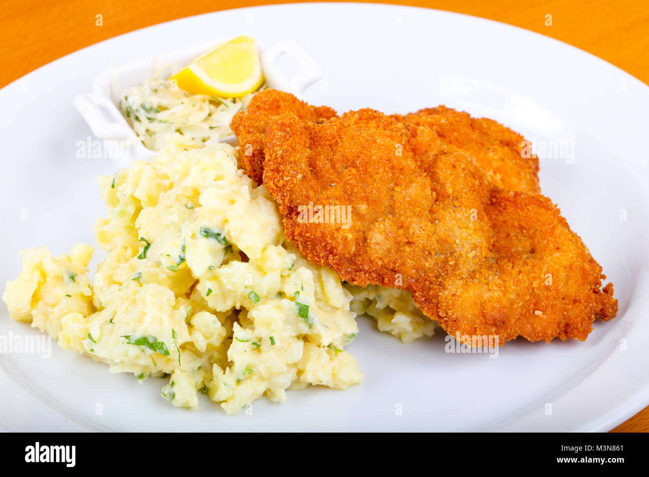 Czech cuisine - schnitzel with cabbage and lemon Stock Photo - Alamy
