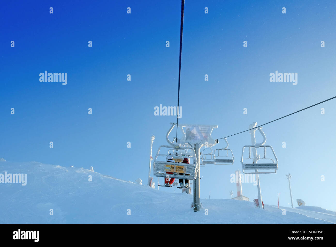 Skiers on a Chairlift at The ski resort of Ruka in Finland Stock Photo