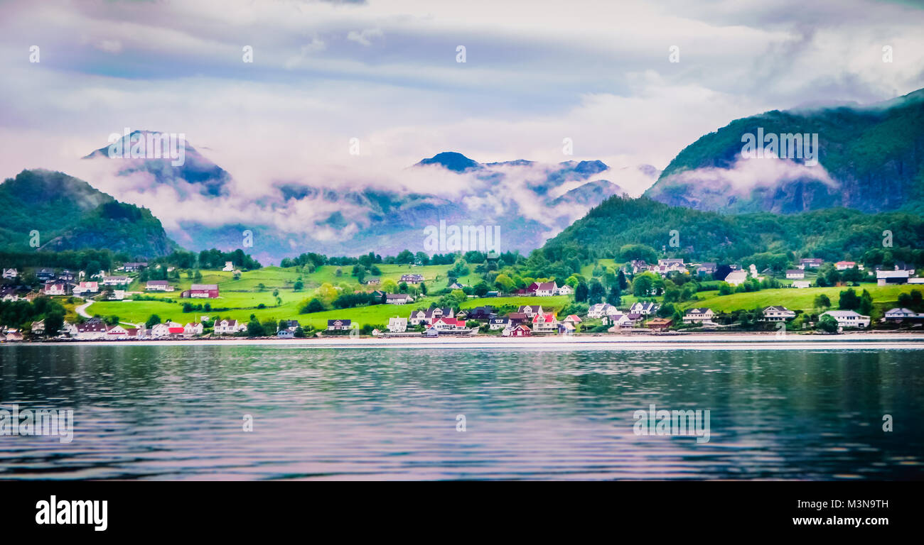 Waiting for ferry crossing looking up to this beautiful small little town in Norway while travelling from Odda to Stavanger Stock Photo