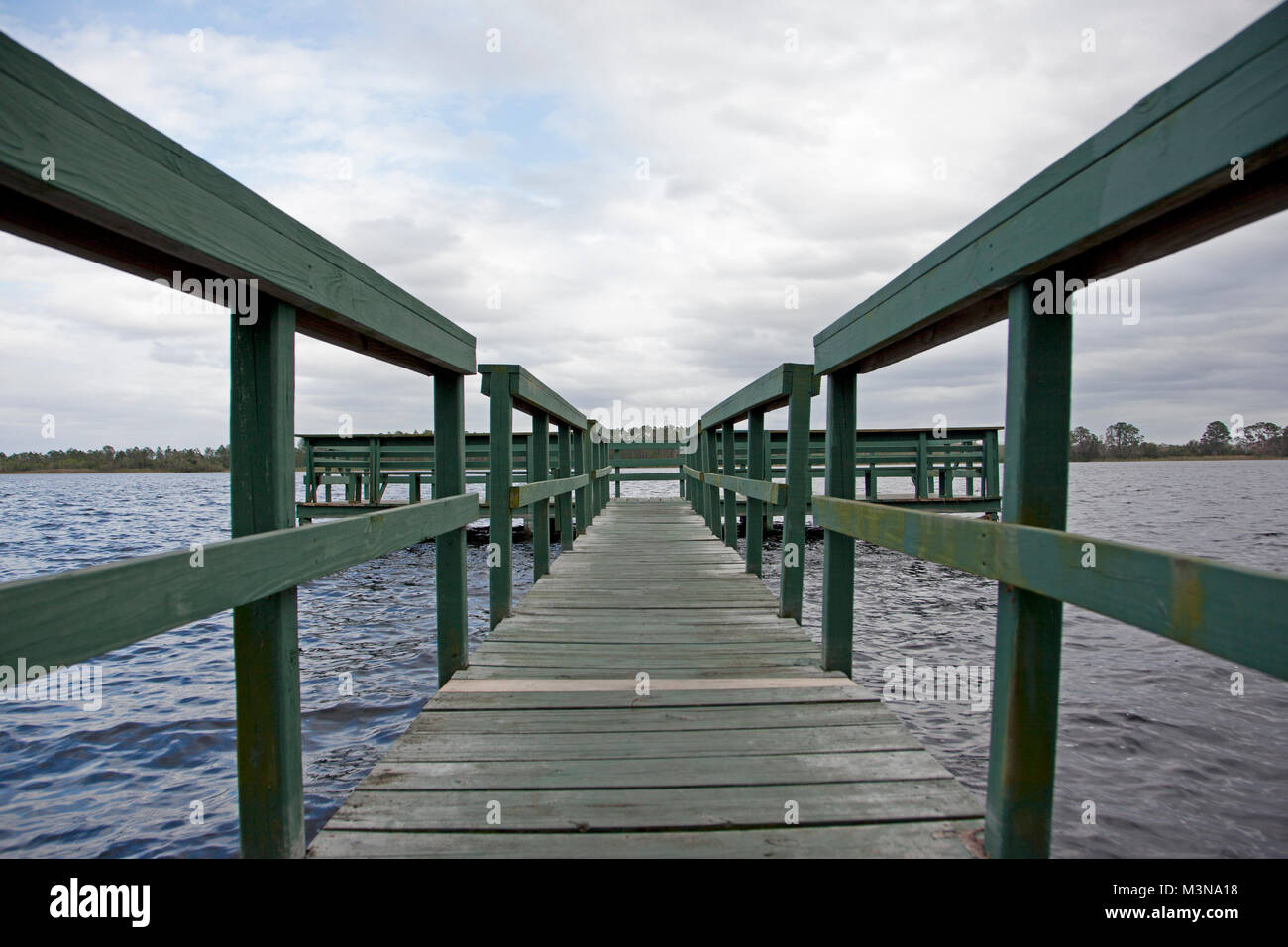 a beautiful Florida day with blue sky by a green wooden wharf at Old Lake Davenport, Florida