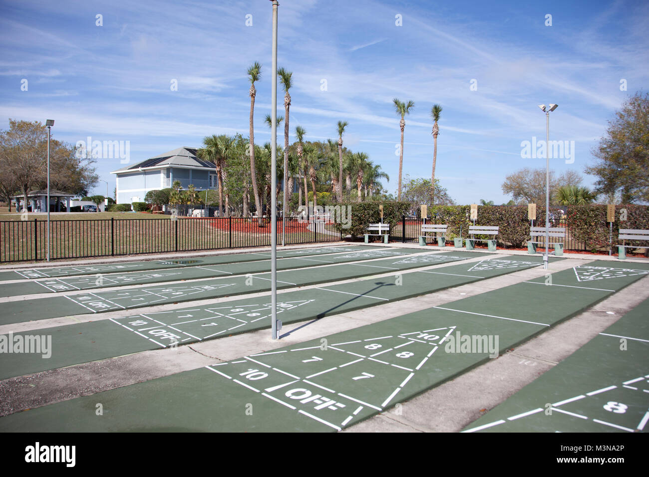 a row of empty shuffleboard courts waiting for players on vacation