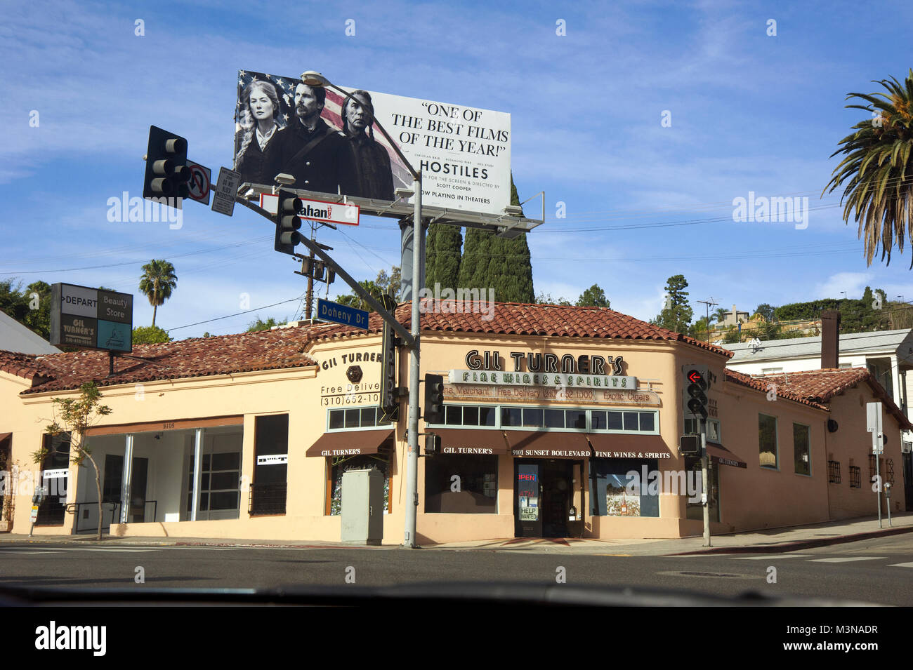 Billboard on the Sunset Strip promoting the movie Hostiles over Gil Turner's Liquor shop in West Hollywood, Los Angeles, CA Stock Photo