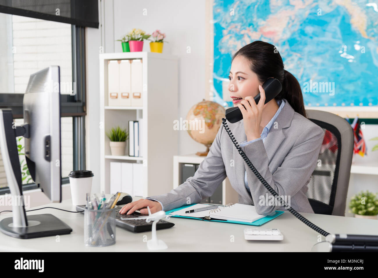 beautiful elegant female office worker looking at computer searching ...