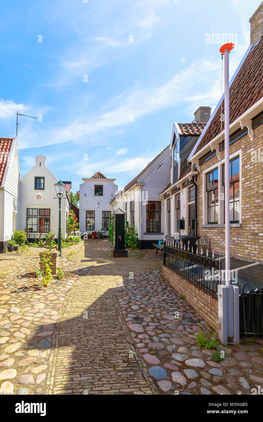 Old and picturesque houses, buildings and architecture typical in downtown Den Burg village on the wadden island Texel on a sunny day in Summer Stock Photo