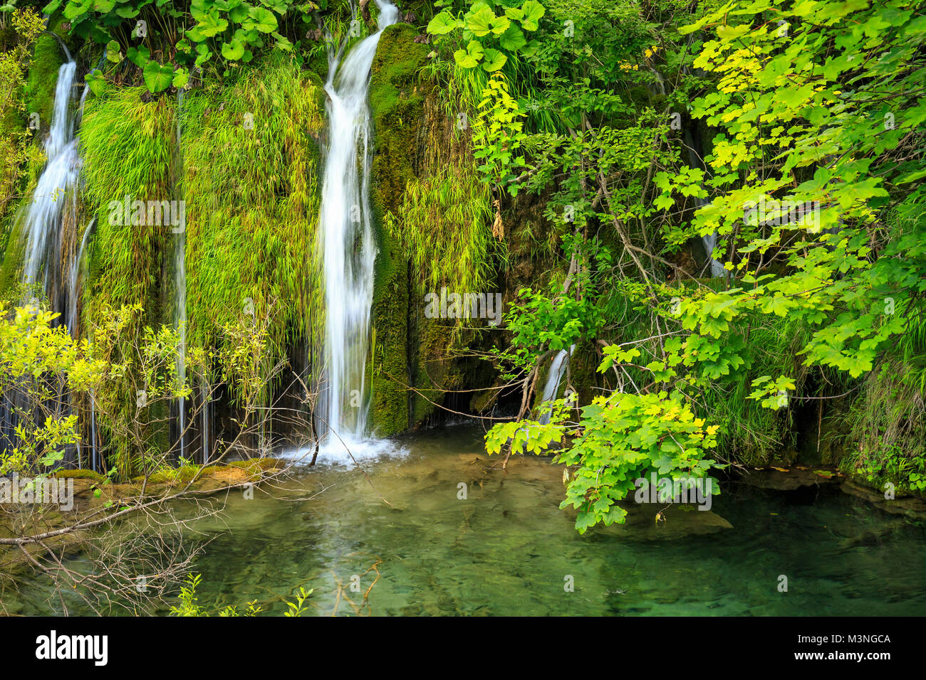 Close up of blue waterfalls in a green forest during daytime in Summer.Plitvice lakes, Croatia Stock Photo