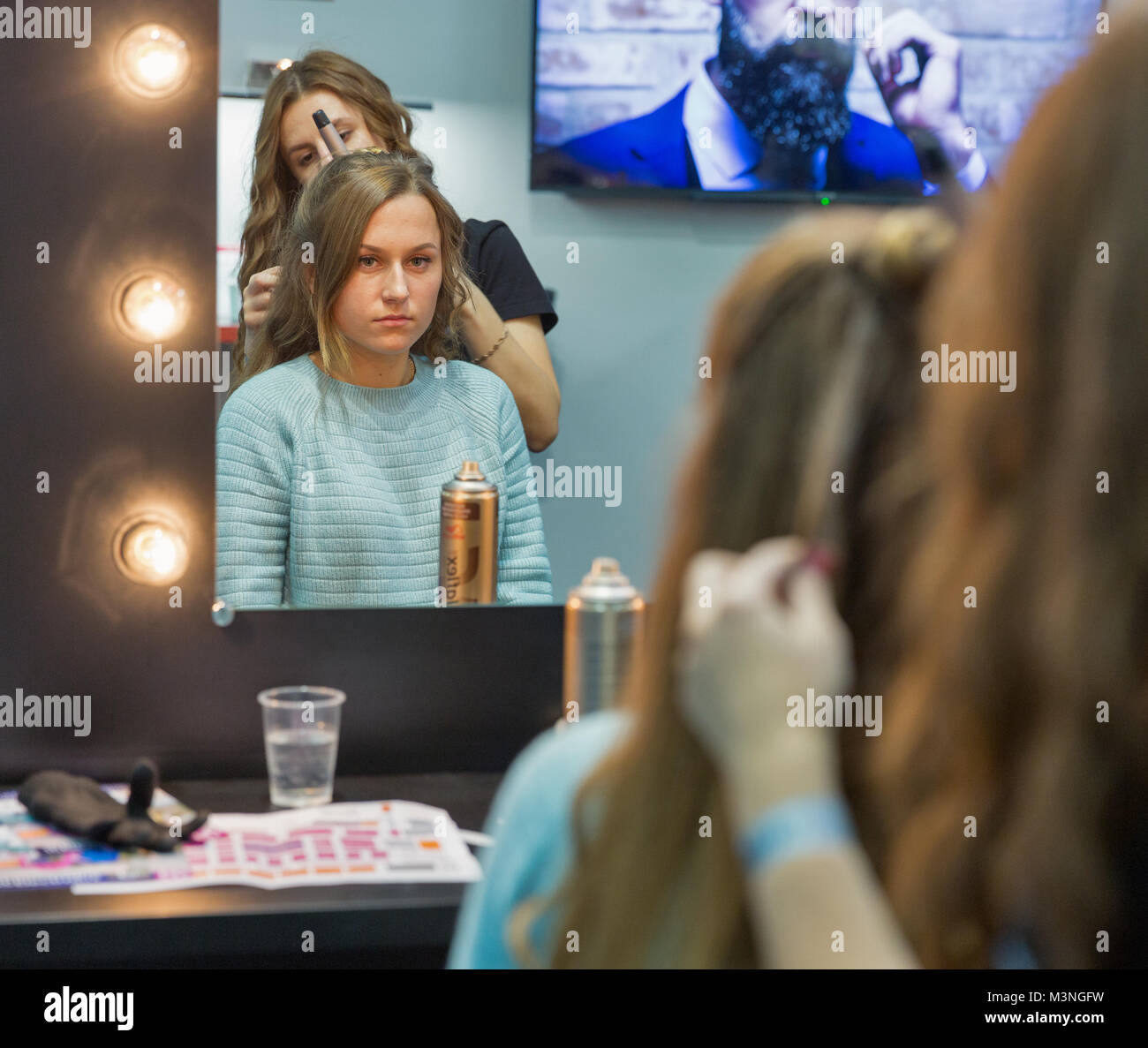 KIEV, UKRAINE OCTOBER 07, 2017 Hairdresser makes hairstyle on