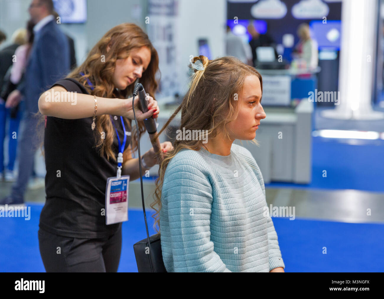 KIEV, UKRAINE OCTOBER 07, 2017 Hairdresser makes hairstyle on