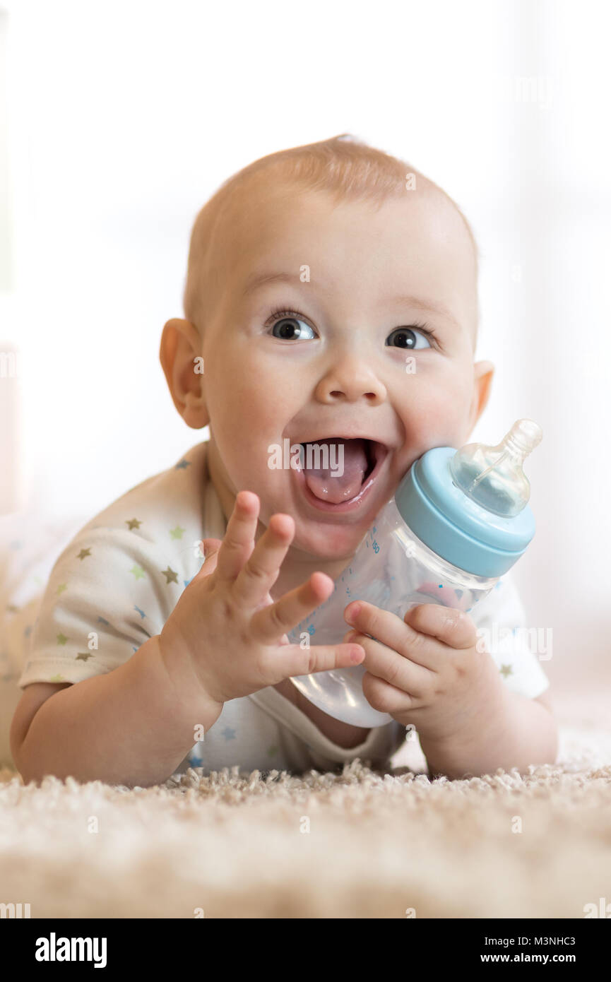 Cute baby drinking water from bottle Stock Photo