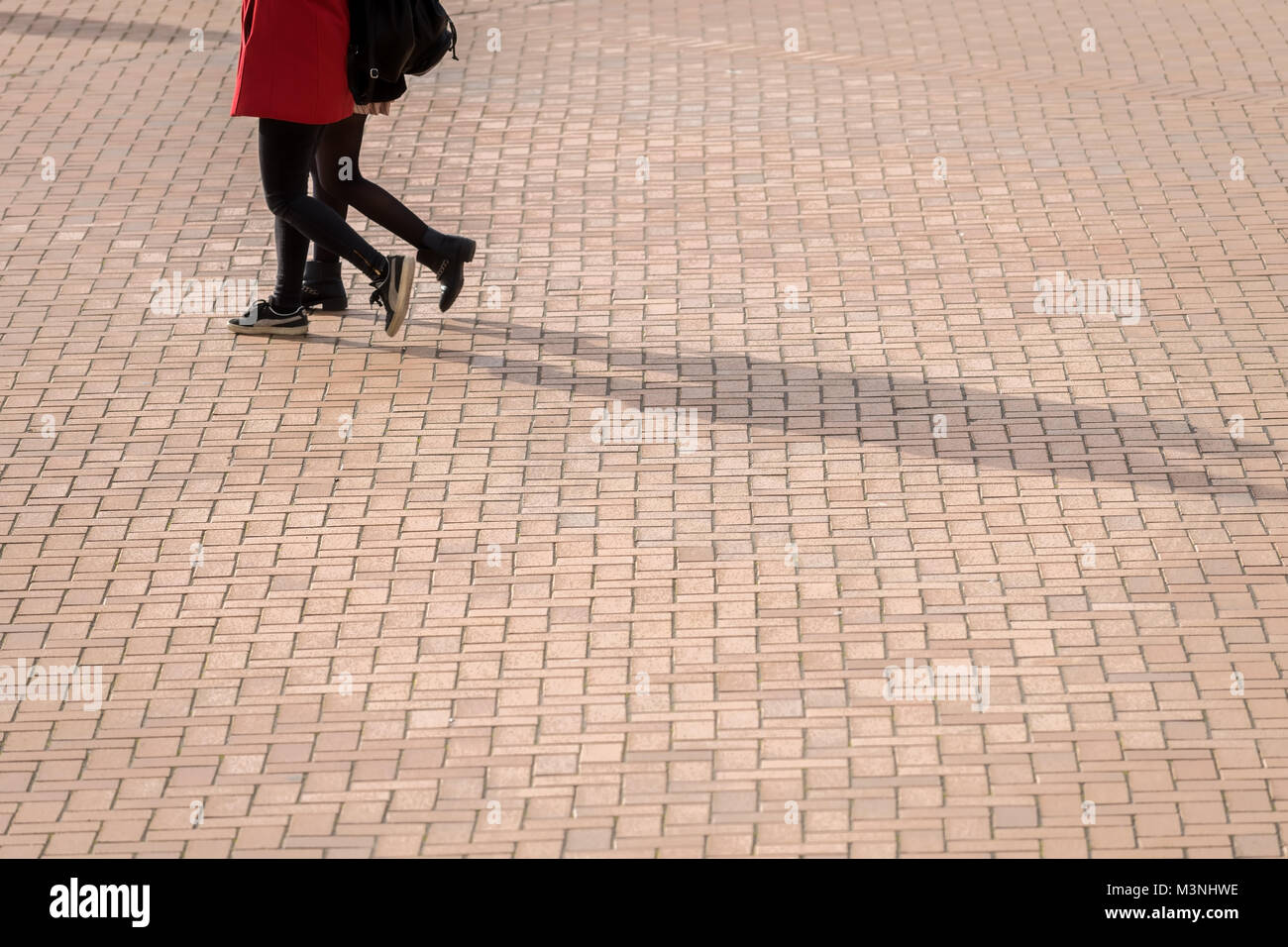 Tourists walk on the brick floor Stock Photo