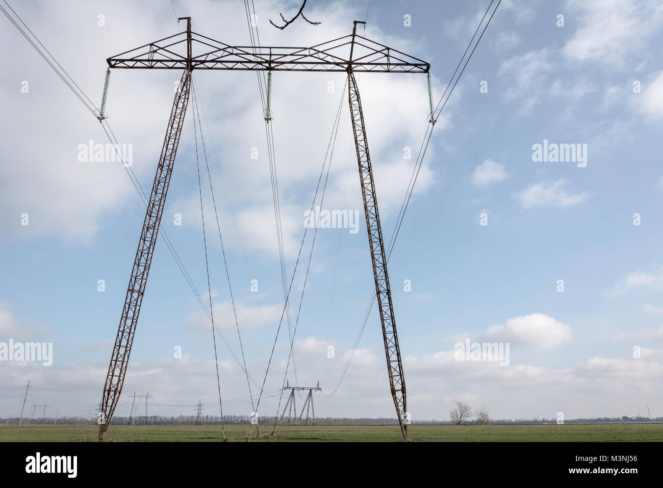 Electricity distribution. Pillars of high voltage in the Moldavian landscape. Stock Photo
